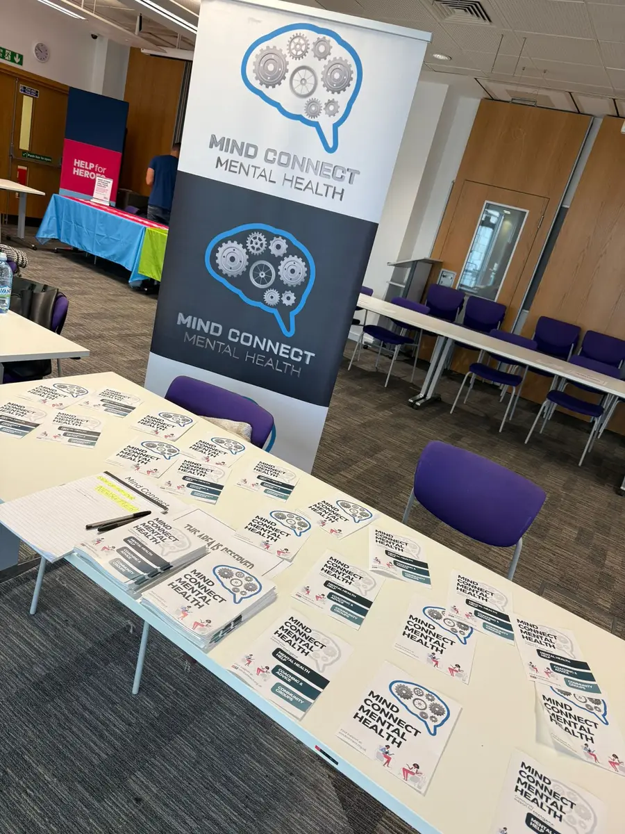 Mind Connect banners and leaflets set out on tables at a community event