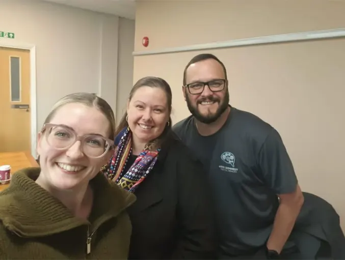 Cathy, Holly and Lee from Mind Connect, smiling together in a meeting room